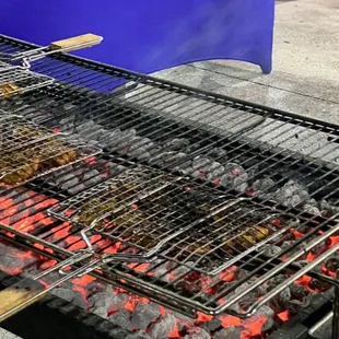 a barbecue grill with meat on it