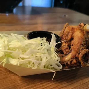 a basket of fried chicken with a side of coleslaw