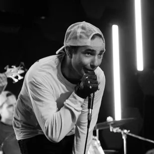 Audience member singing a song on stage with us