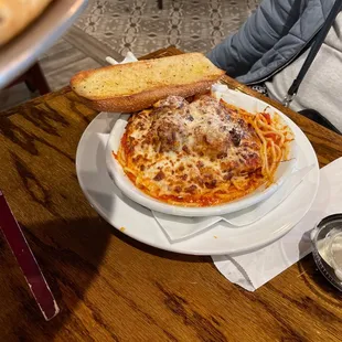a plate of spaghetti and bread