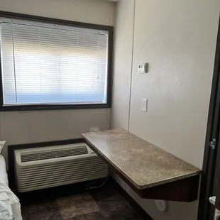 This is the shelf that can double as a desk, table or luggage shelf.