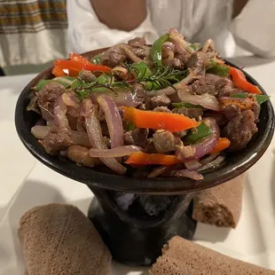 Fim Tibs (Chopped Lamb) served over a hot coal container. The meal is as delicious as it looks.