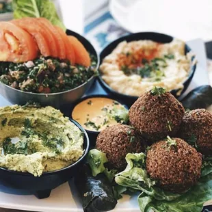 a platter of falafel, hummus, hummus