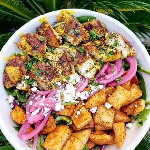 Grilled Chicken Salad - Hot Chicken, Pickled onions, pita croutons, feta cheese, Mediterranean Salad, Mediterranean Vinaigrette.