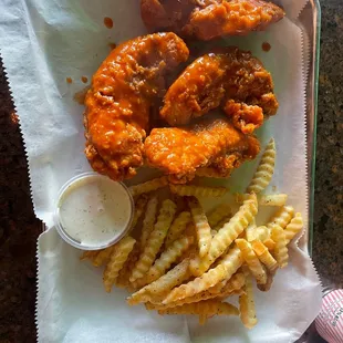 Hand battered chicken tenders tossed in Buffalo