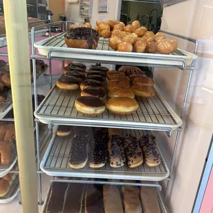 a variety of donuts in a display case