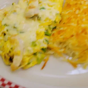 Chicken fajitas omelet with hash browns and fresh fruit.