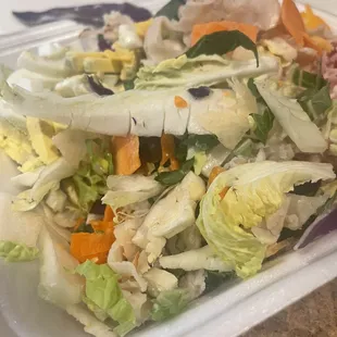 a salad in a styrofoam container