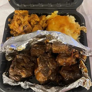 Oxtails with sides of Macaroni and Cheese Candied Yams