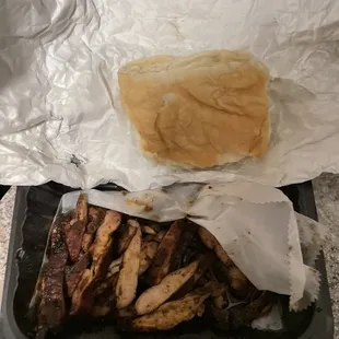 1/2 eaten jerk chicken sandwich