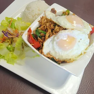 Basil chicken with two fry eggs n steam rice plus salad!