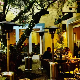 Olive tree centers the courtyard dining area