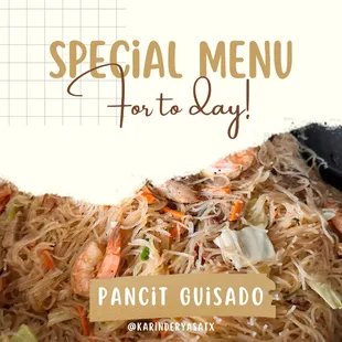 a plate of noodles with shrimp and carrots