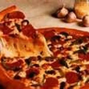 a pepperoni pizza with a slice taken out of it