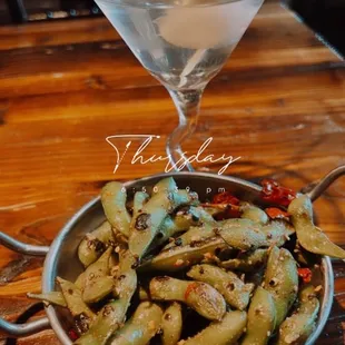 a bowl of stir frys with a martini in the background