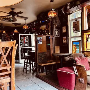 the interior of a bar with stained glass windows