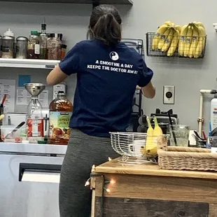 a woman preparing a smoothie