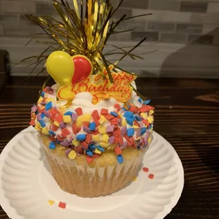 a cupcake with sprinkles and decorations
