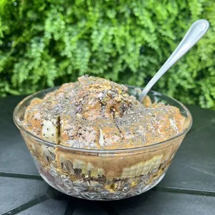 Brainiac bowl with açaí base, banana, blueberries, pumpkin seeds, raisins, chia, honey, granola &amp; almond butter