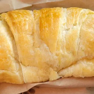 a croissant in a paper bag