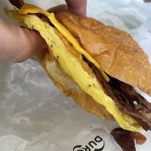 Greasy, soggy bacon, egg, and cheese croissant (BEC Croissant Sandwich)