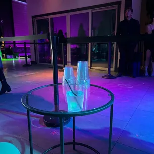 a table with two cups of water on it