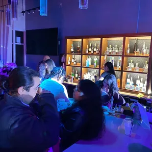 a group of people sitting at a bar