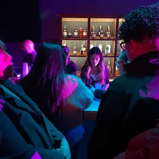 a group of people sitting at a bar