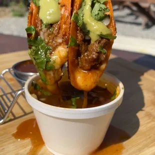 a hand holding a taco