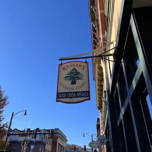 a sign hanging from the side of a building