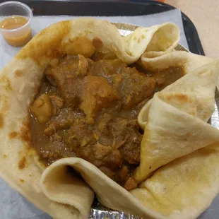 Up close and personal with my chicken curry with a cup of hot sauce