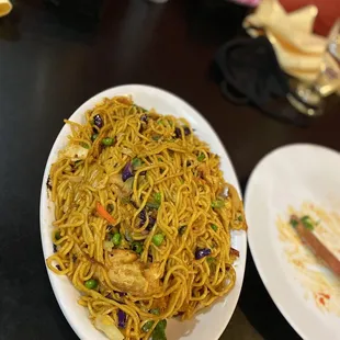 a plate of noodles with meat and vegetables