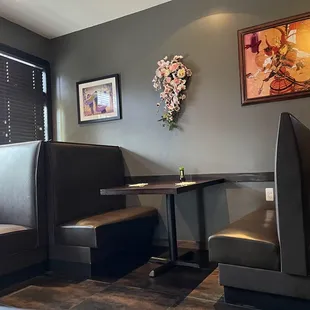 a corner of a restaurant with a table and chairs