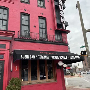a red building with a black awning