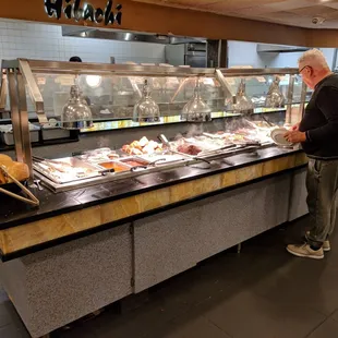 a man standing in front of a buffet