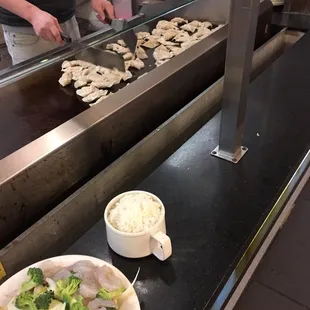 Cooking dumpling while waiting on hibachi..