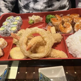 Dinner box with shrimp tempura, California roll and shumai.