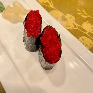 three sushi rolls on a plate