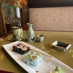 a plate of sushi and chopsticks