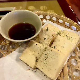 a bowl of sauce and a plate of food