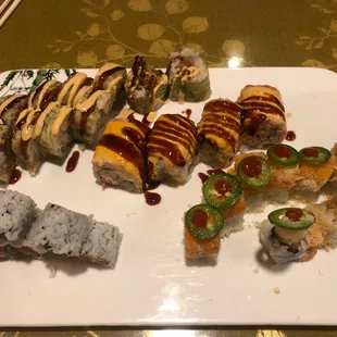 Tiger Roll (top left) Spicy Tuna with Crunch Roll (bottom left) Fancy Toro Roll (Center) Hot Hot Roll (bottom right)