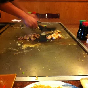 a person cutting up a steak
