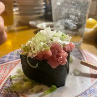 a sushi roll on a plate with chopsticks