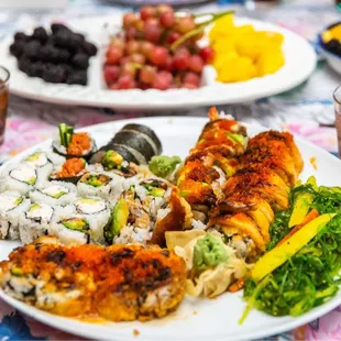 a plate of sushi and other foods