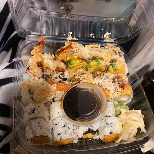 a plastic container filled with sushi