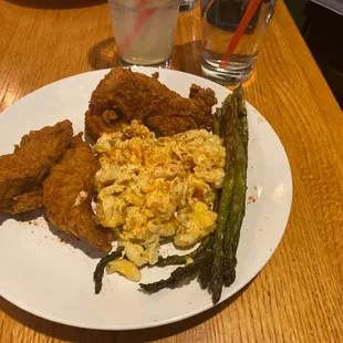 a plate of fried chicken and asparagus
