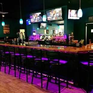 a bar with purple lighting