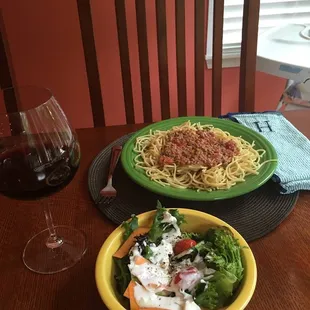 Meat Bolognese served atop pasta, salad w/ home made bleu cheese