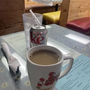 Beverages (coffee &amp; Diet Coke) and menus (under the table&apos;s glass)