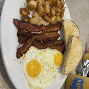 All American breakfast with sourdough, sunny side up eggs, bacon and breakfast potatoes